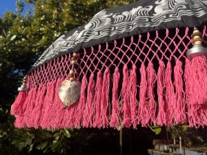 pink patio umbrella with fringe